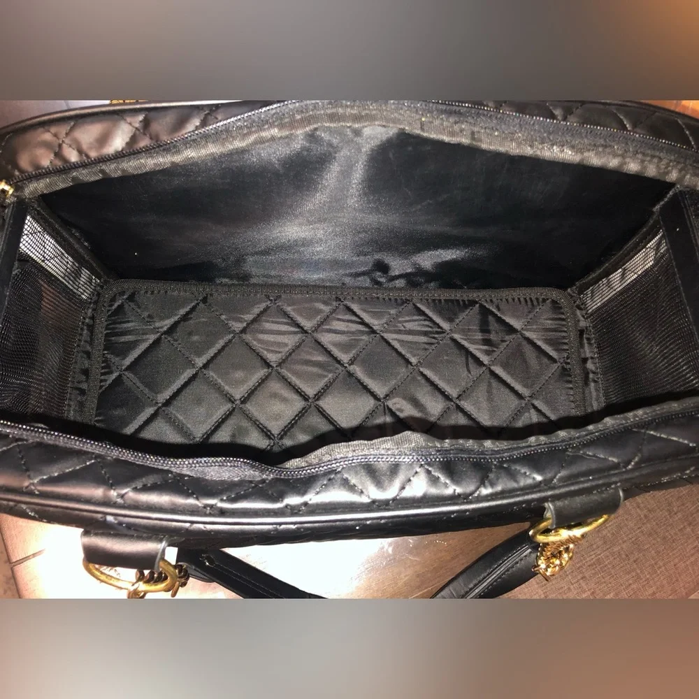 black quilted pet carrier tote with gold chain handles.